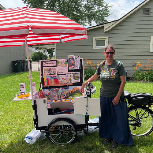Sarah Simon standing next to the book bike