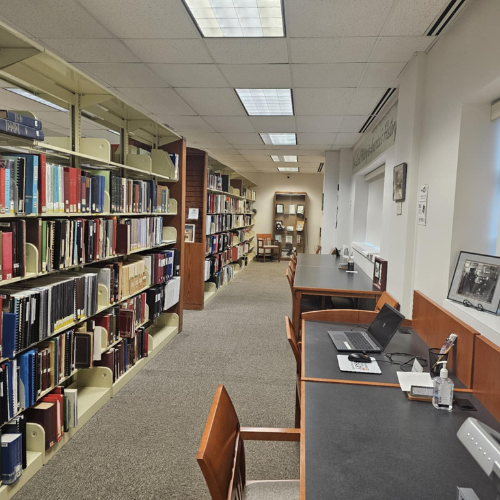 Image looking down the shelves inside Local History and Genealogies