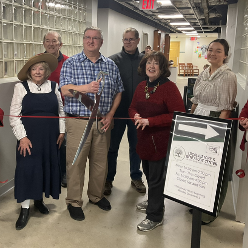 Local History and Genealogy's employees at their ribbon cutting