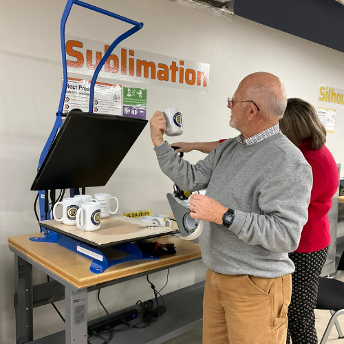 patron admiring a mug they made in the Maker Lab